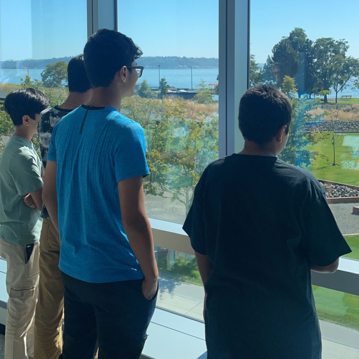 Students look out of the window at the water during a field trip